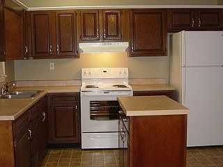 Immaculate kitchen with refrigerator and new self-cleaning range.