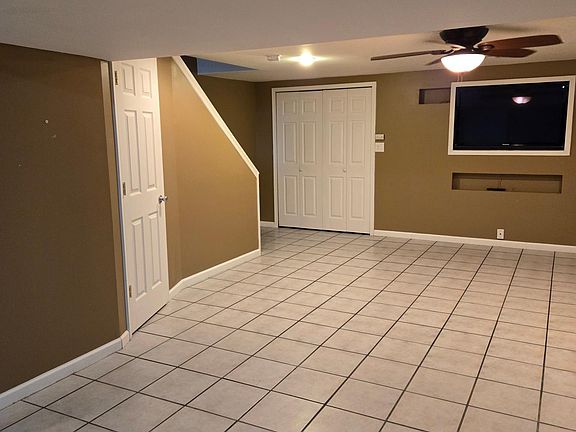 fished lower level family room with tv