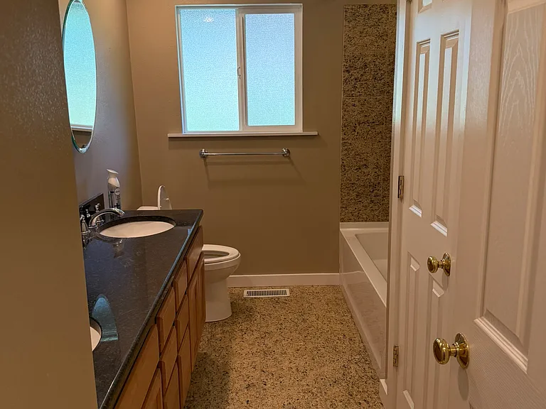 Main bathroom, located at the top of the stairs from the main room. Double sink. Large storage closet and glass shelved nook for storing towels or other items.