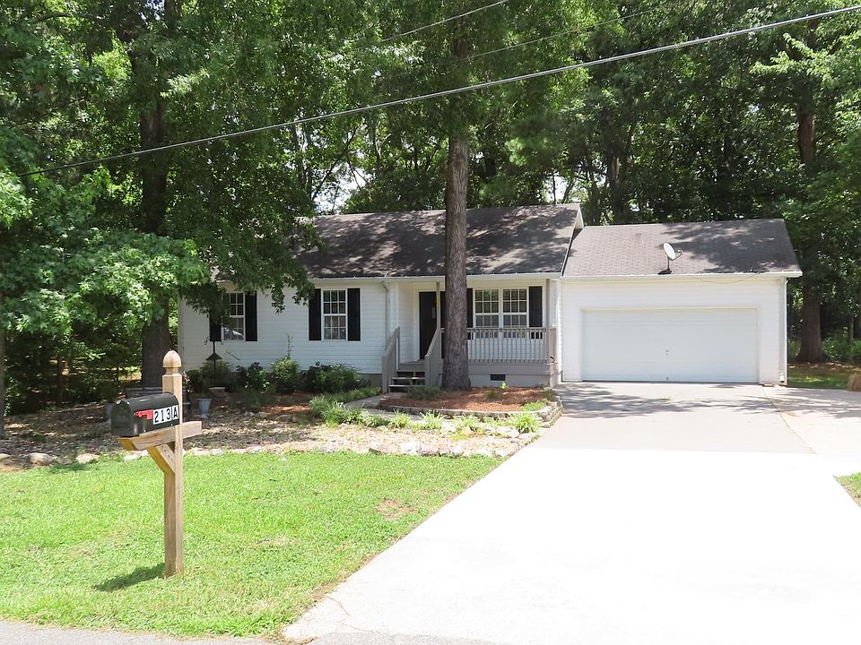 Covered Front Porch, 2 Car Garage with additional parking to the side.