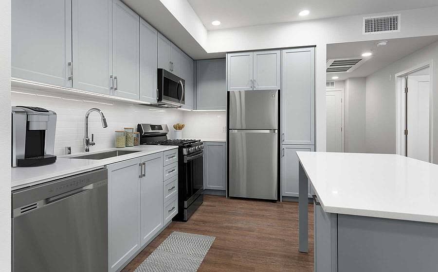 Building A Avalon Design kitchen with quartz countertops, stainless steel appliances, backsplash and island
