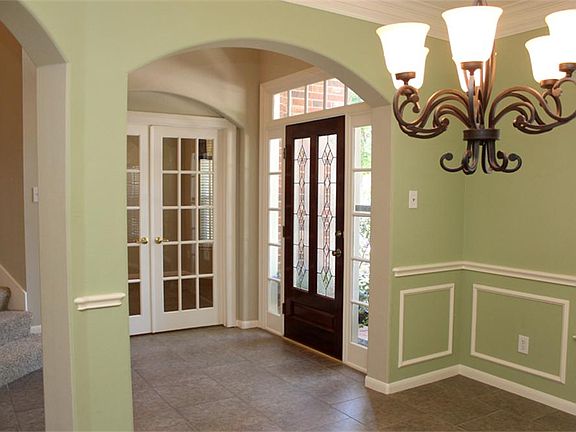 ARCH DOORWAY LEADS THE WAY TO THE FORMAL DINING ROOM.