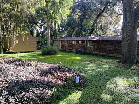 View of the back of the house and shed/ workout room from side yard