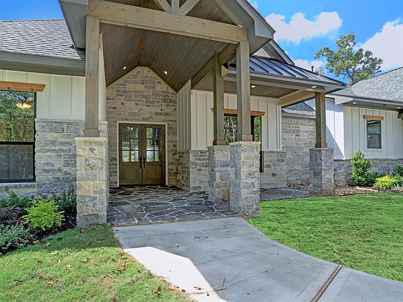 Extended covered front flagstone porch with cedar plank ceiling