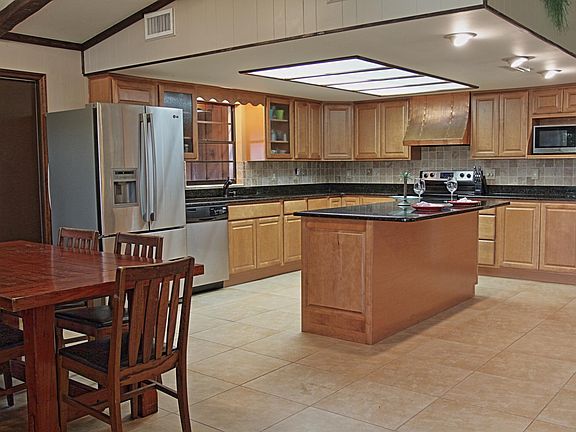 The great room has a dining space, island breakfast bar with granite and living room which is perfect for entertaining.