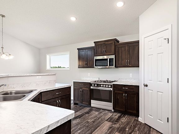 This home includes a full suite of stainless steel kitchen appliances including the refrigerator.