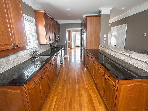 The kitchen features ample cabinetry with pull out shelves i