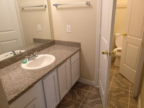 Large bathroom with tiled floors and Granite counter top