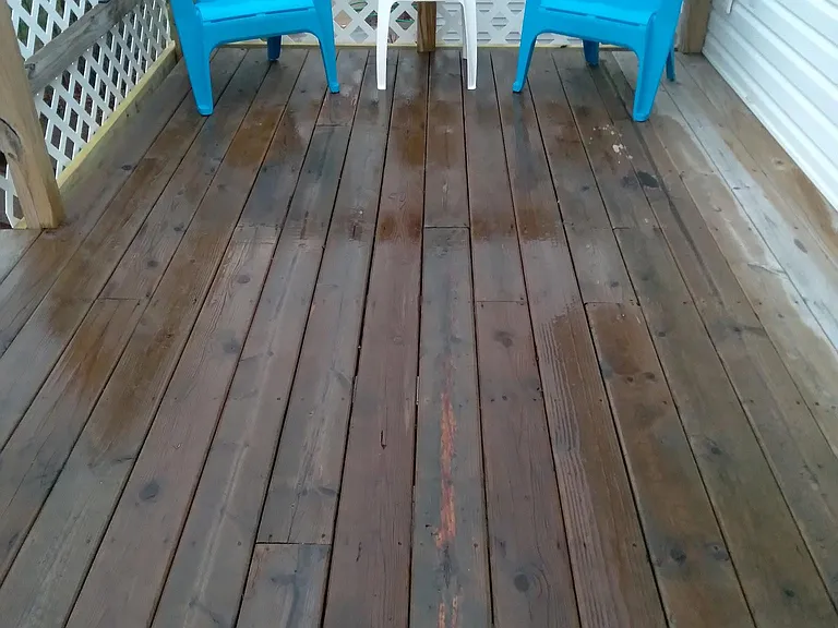 Large deck with chairs and a table.