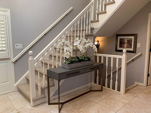 Main entry stairs to upper and lower levels - view from family room entrance to entryway