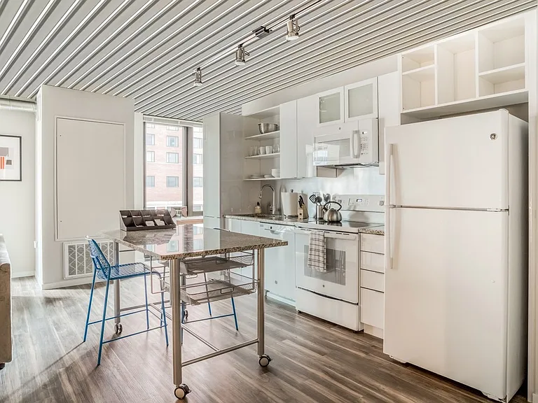 63 E Lake Apartments kitchen with white color scheme