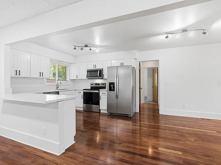 Kitchen with breakfast bar open to living room