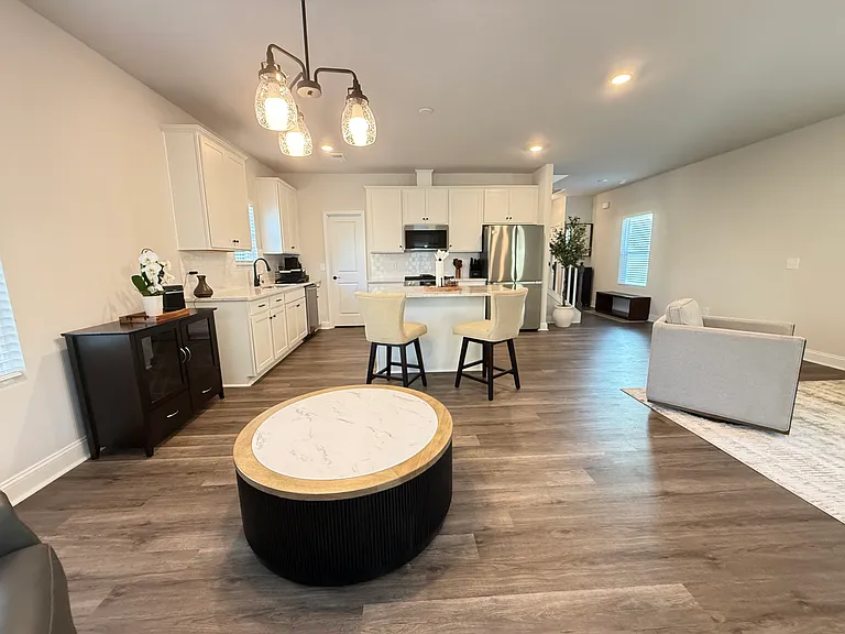 Fully equipped chef's kitchen with stainless steel appliances and marble-style island.