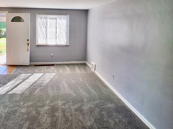 Spacious living room to the left of front entrance with two windows for lots of natural light and a coat closet.