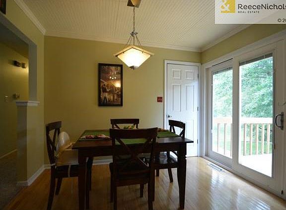 Spacious eating area overlooks the deck and tree lined backyard.