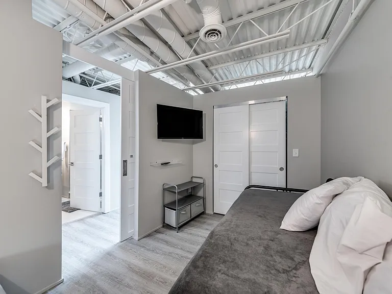 1st floor bedroom with closet and smart TV.