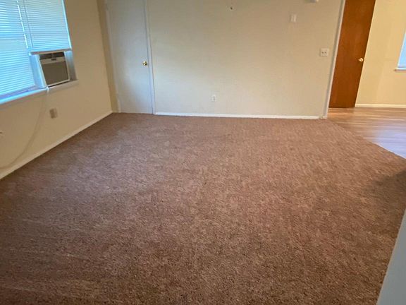 2cd view of living room with a large storage area closet.