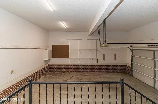 Enclosed attached 2-car garage connected to the kitchen.