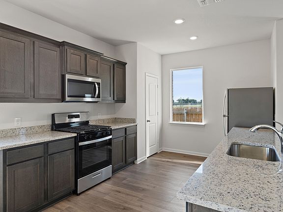 The kitchen of the Cassidy has beautiful wood cabinetry.