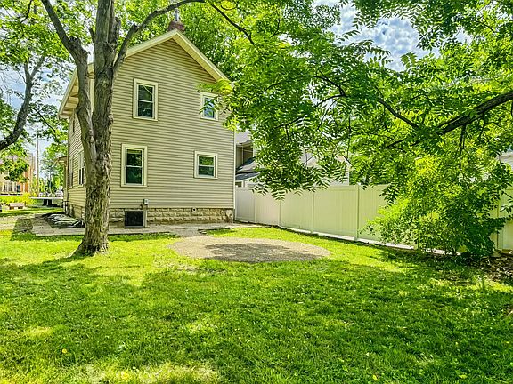 Enjoy a spacious backyard with fire pit and trees to shade the yard