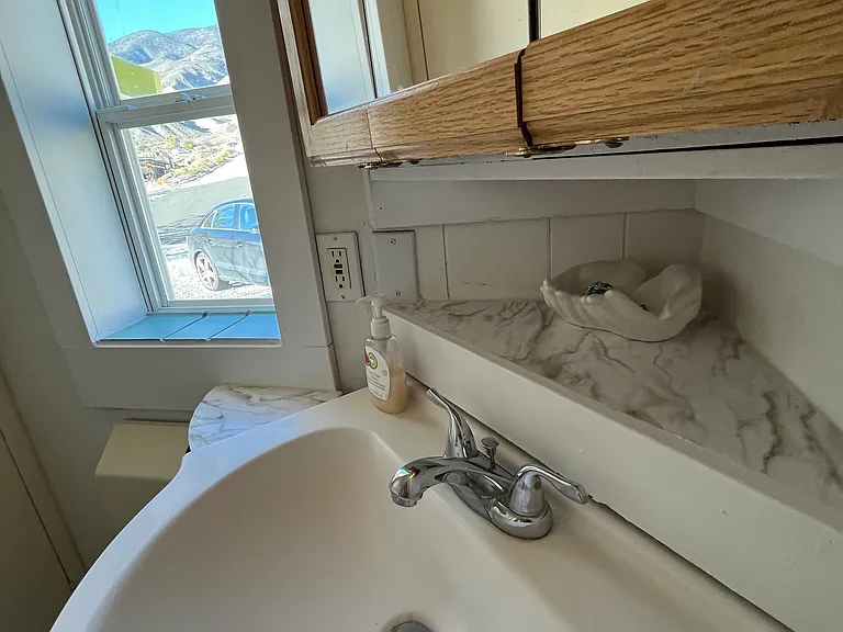 Bathroom #2 with view,sink and 3 door medicine/ supply cabinet.