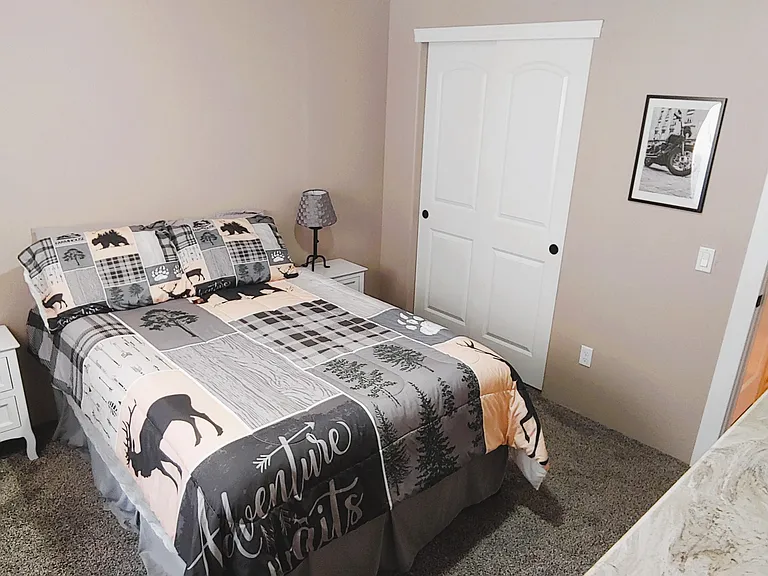 Spare bedroom, full size bed, smart TV.