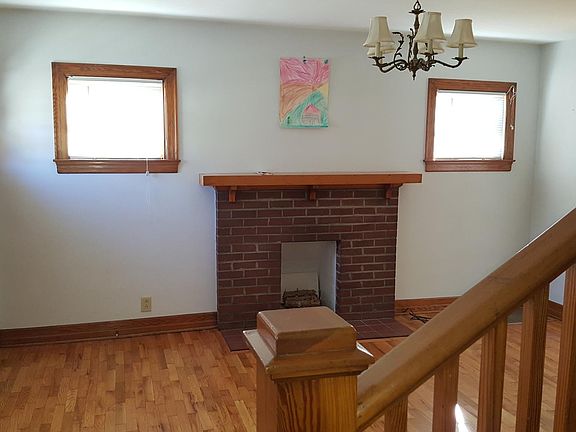 Living room, front door at left and dining room entrance at right