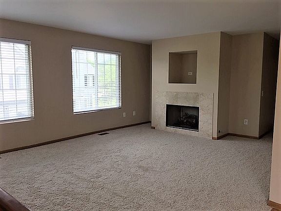 Large living room with gas fire place. New carpet, paint and blinds.