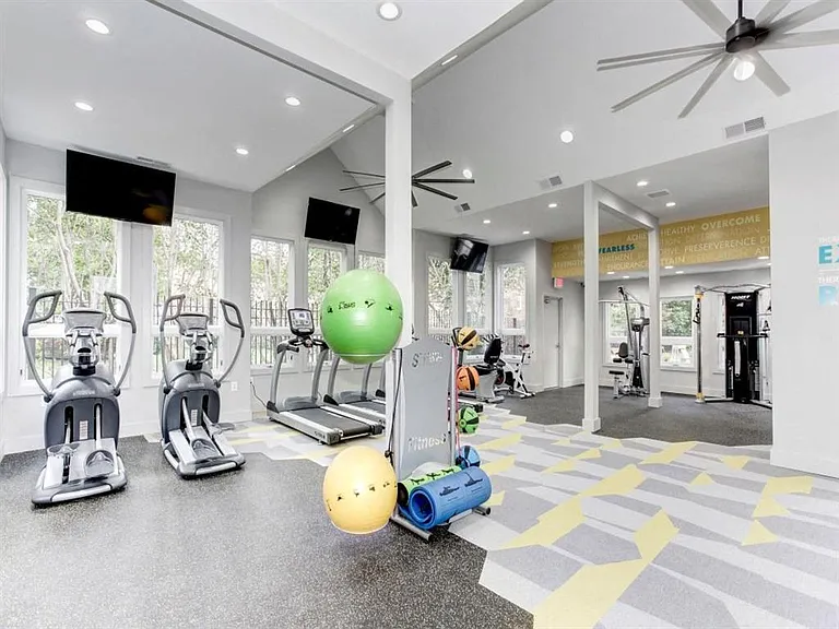 24-Hour Fitness Center with Cardio Machines, Free Weights, and Yoga Area