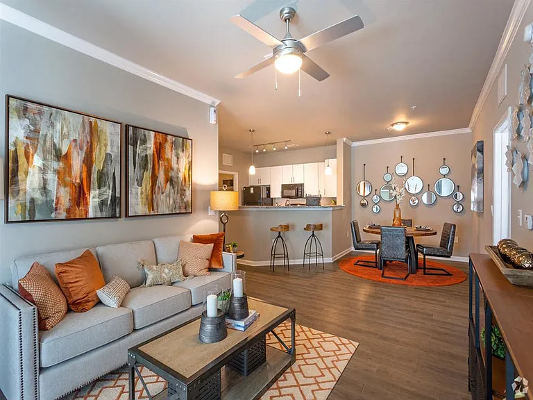 Open-concept living room with view of kitchen and dining area