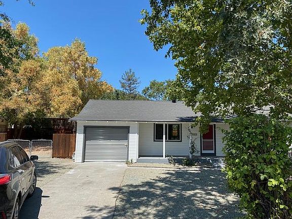 ANOTHER VIEW OF FRONT OF HOUSE WITH PARKING SPACE