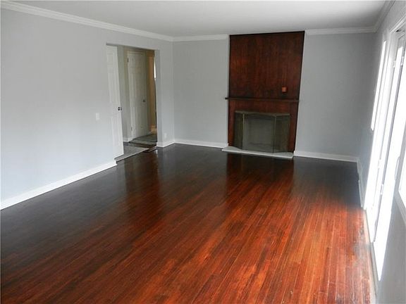 Beautiful living room with gleaming hardwood floors and lfireplace.