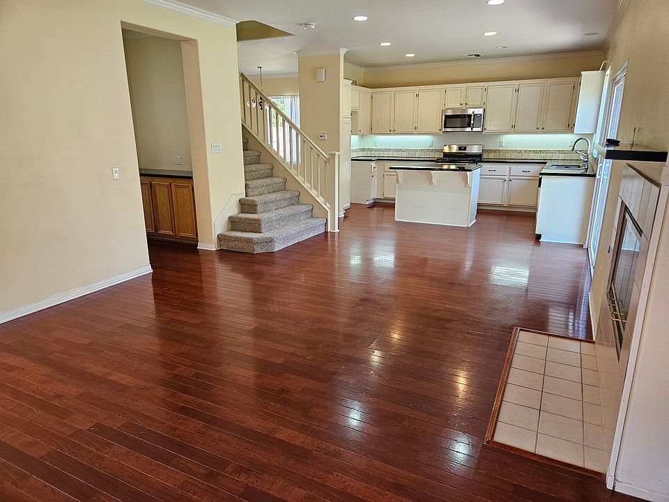 Family room area with Kitchen in background. Fireplace (gas) on the right. New carpets on the stairs and upstairs.