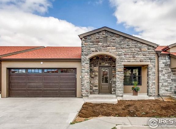 Two car tuscan stucco stone home