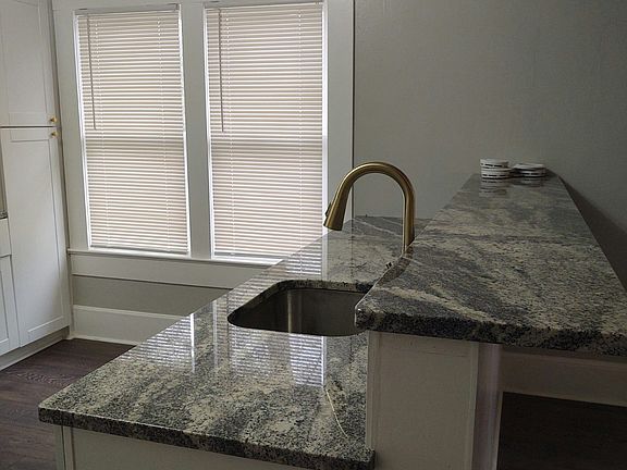 Open concept kitchen with beautiful granite counters