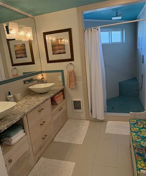 Upstairs bathroom double sinks an large shower