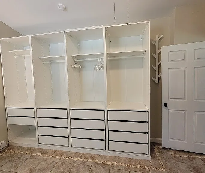 Convenient clothes storage in master bath next to stacking washer & dryer