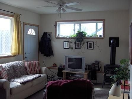living room of cottage, gas heater looks like a wood stove for extra warmth and charm