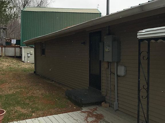 View of back of house up to detached garage/barn house. Separately rental from house.