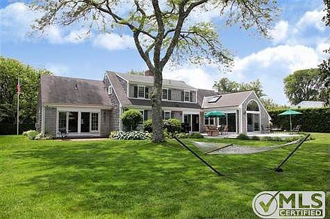 This photo encapsulates the relaxing lifestyle this home offers. Its generous back yard combines a w