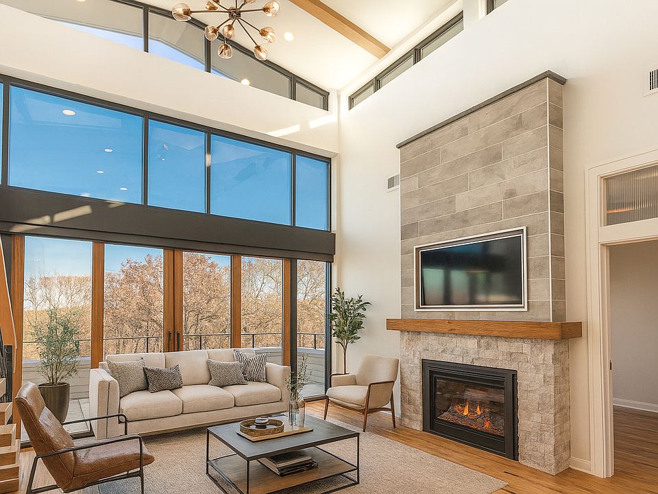 Living Room - Floor to ceiling windows, panoramic views, automatic blinds, double-sided Gas FP, Hickory wood floors, and more! (Virtually Staged)