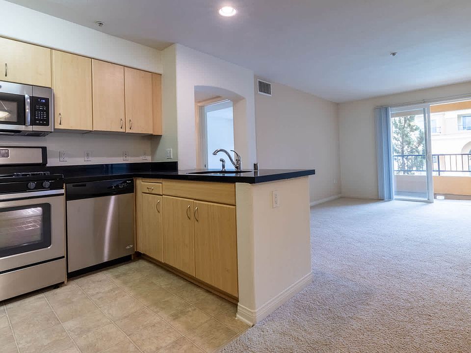 Carpeted Living Room with Balcony