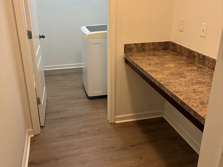 Spacious laundry room with a folding counter and storage