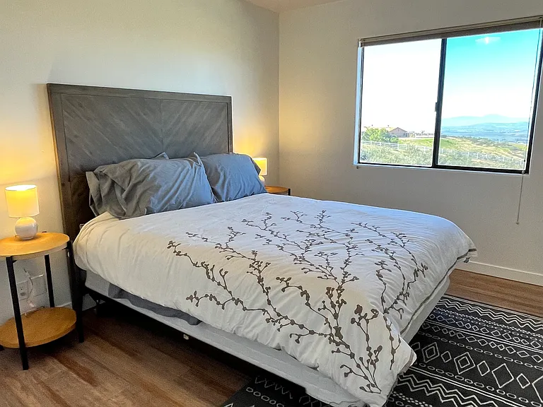 Bedroom #3 which features a queen bed, walk-in closet and sweeping outdoor views