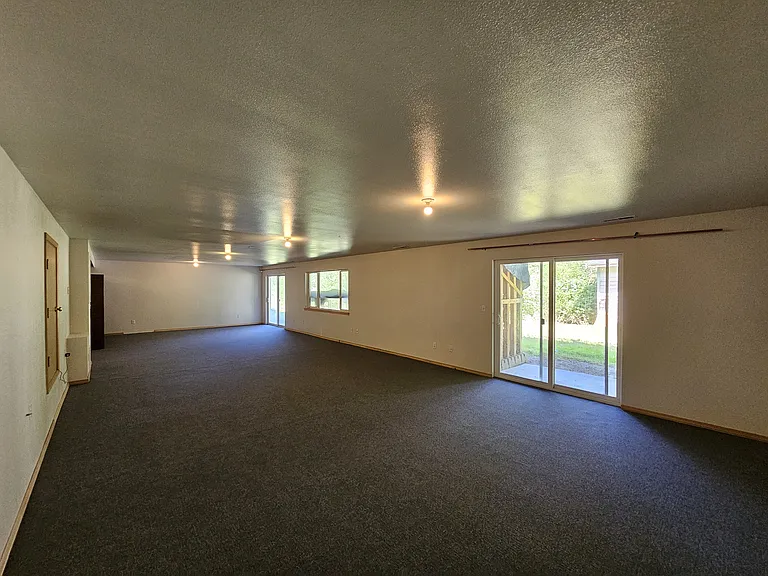 Double sliding glass doors in lower level to access backyard.