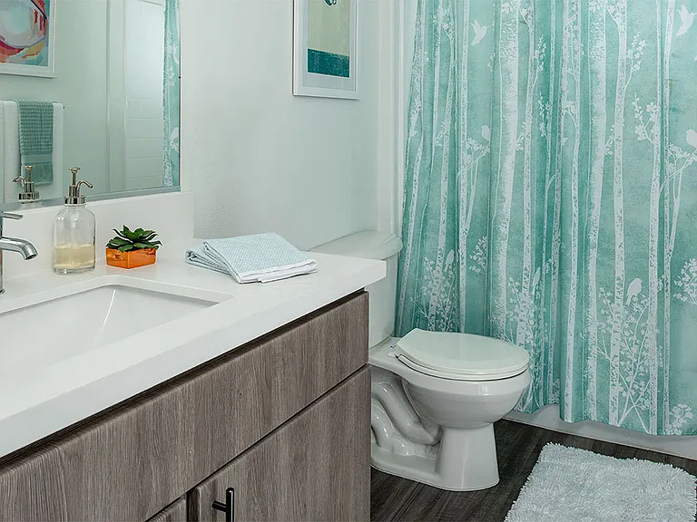 Apartment Bathroom with large soaking tub and hardwood flooring.