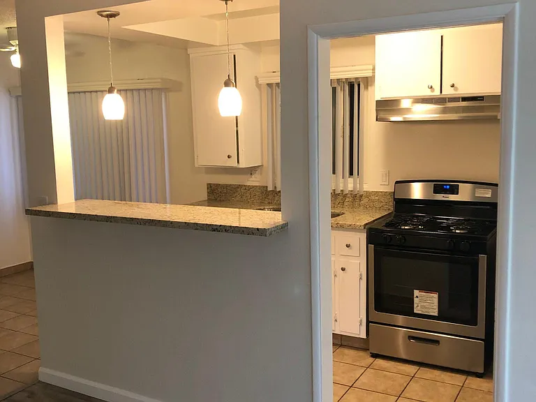 Kitchen overlooks the spacious living room to enjoy shows while you cook.