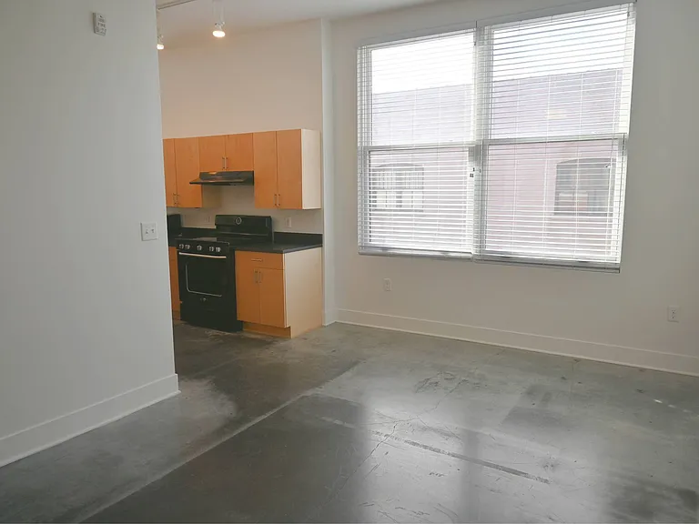 Living room and kitchen entrance in a unit at The Sawyer.