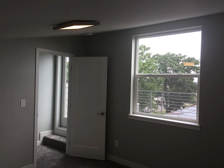 third floor bedroom w/ vaulted ceiling