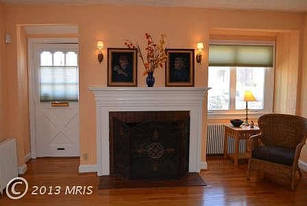 Living Room with Wood Bruning Fpl